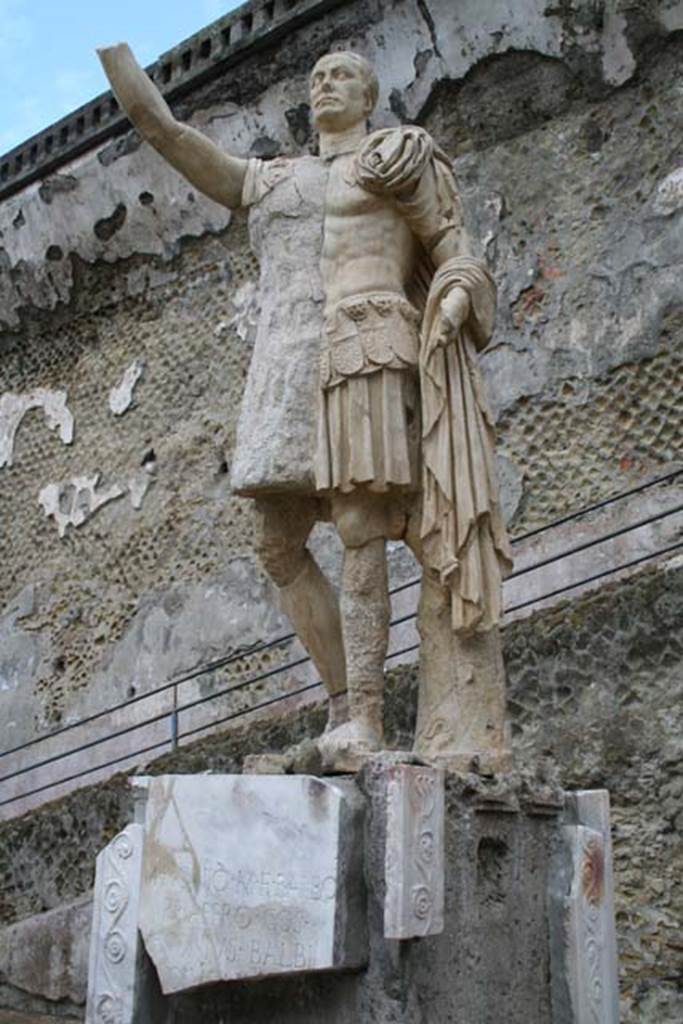 Herculaneum, March 2008. Statue of Marcus Nonius Balbus. Photo courtesy of Sera Baker.
The statue was significantly damaged by the eruption. A volcanic wave demolished the statue from its pedestal. It was partially restored after discovery. 
The head of the proconsul was found during excavations led by Maiuri while a significant part of the torso was restored in 1981.